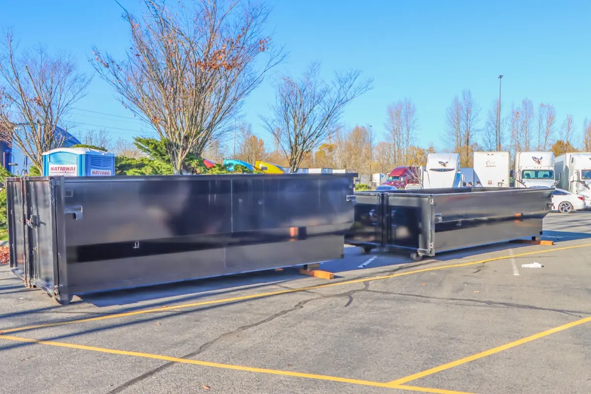 Professional dumpster rental service with roll-off container on residential driveway in Rochester Hills